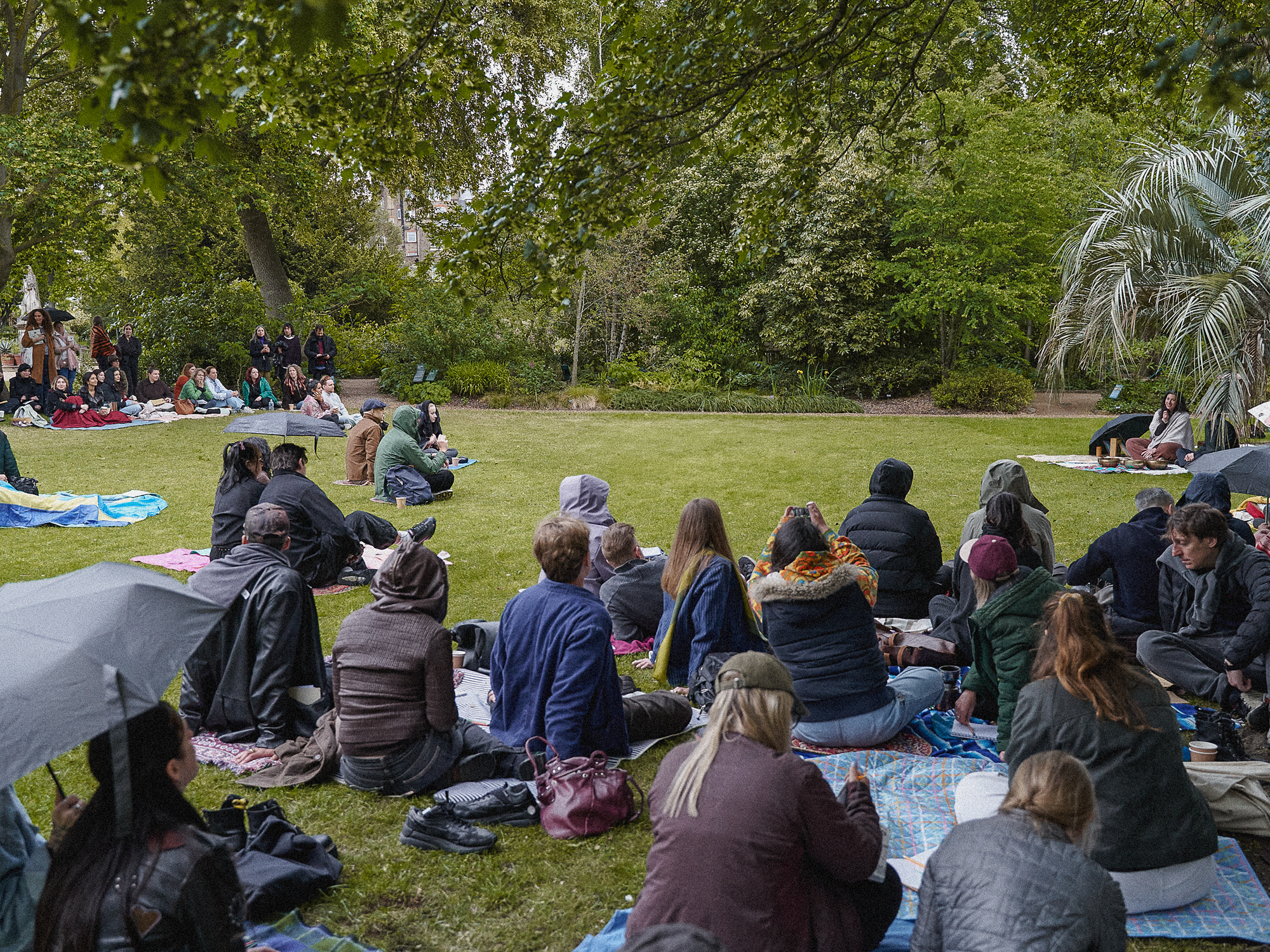 Visitors seated on blankets around the lawn during the Beyond Botanical guided programme.
