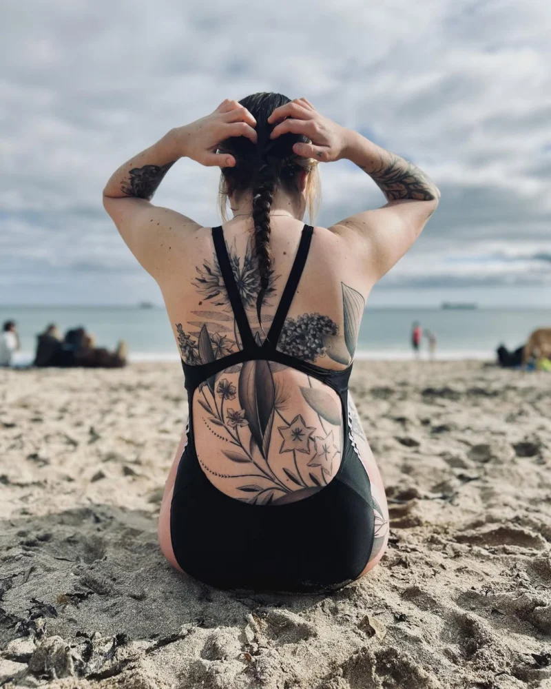 Freehand botanical tattoo across the back