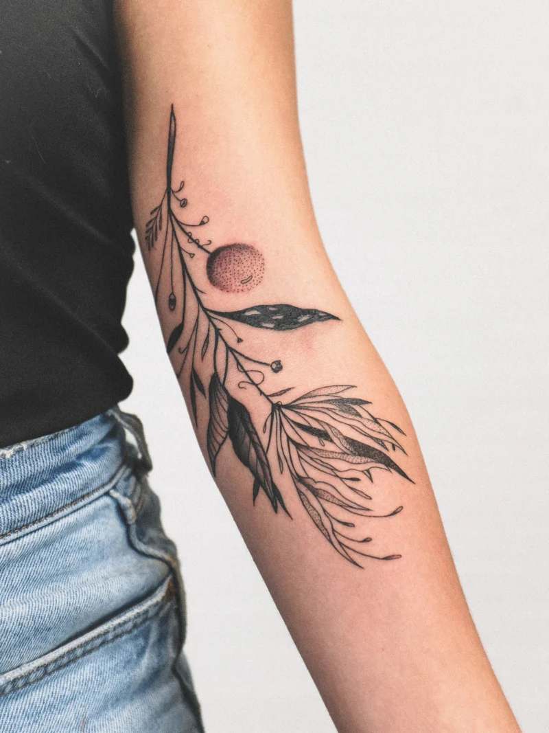 Freehand botanical tattoo across the arms