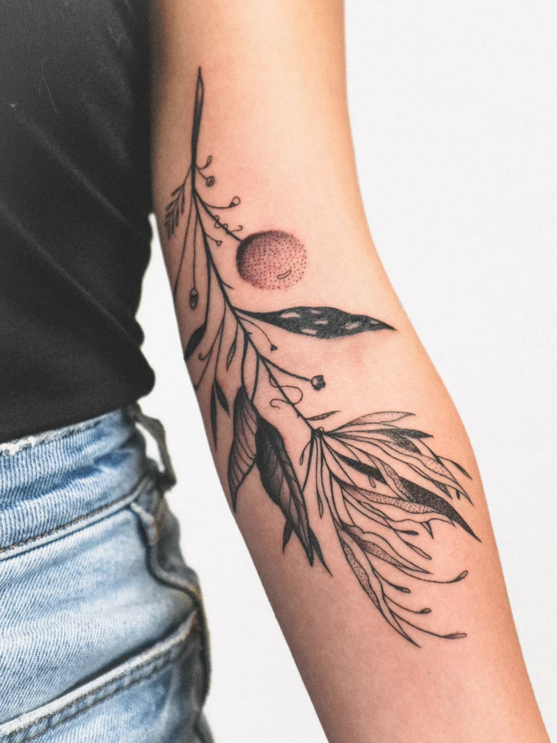 Another view of a freehand botanical tattoo across the arms