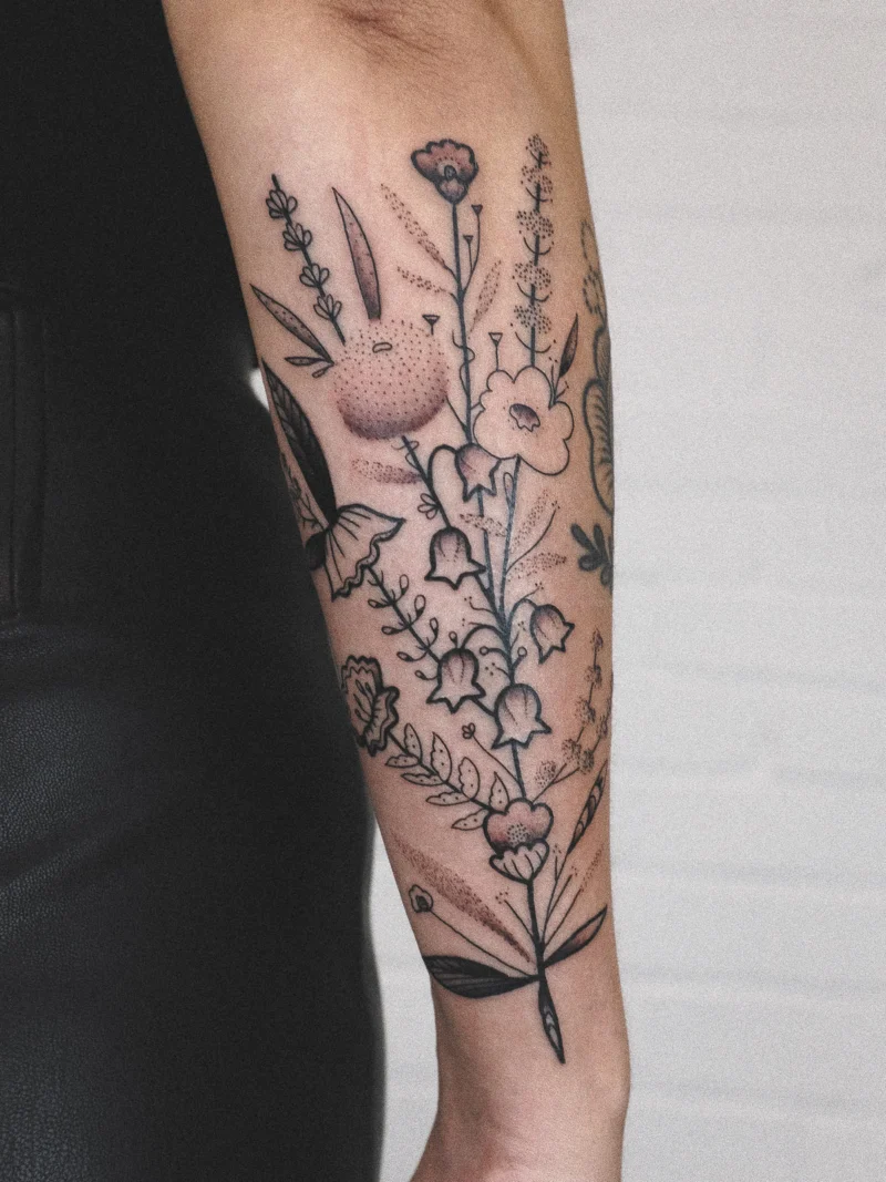 Freehand botanical tattoo across the arms