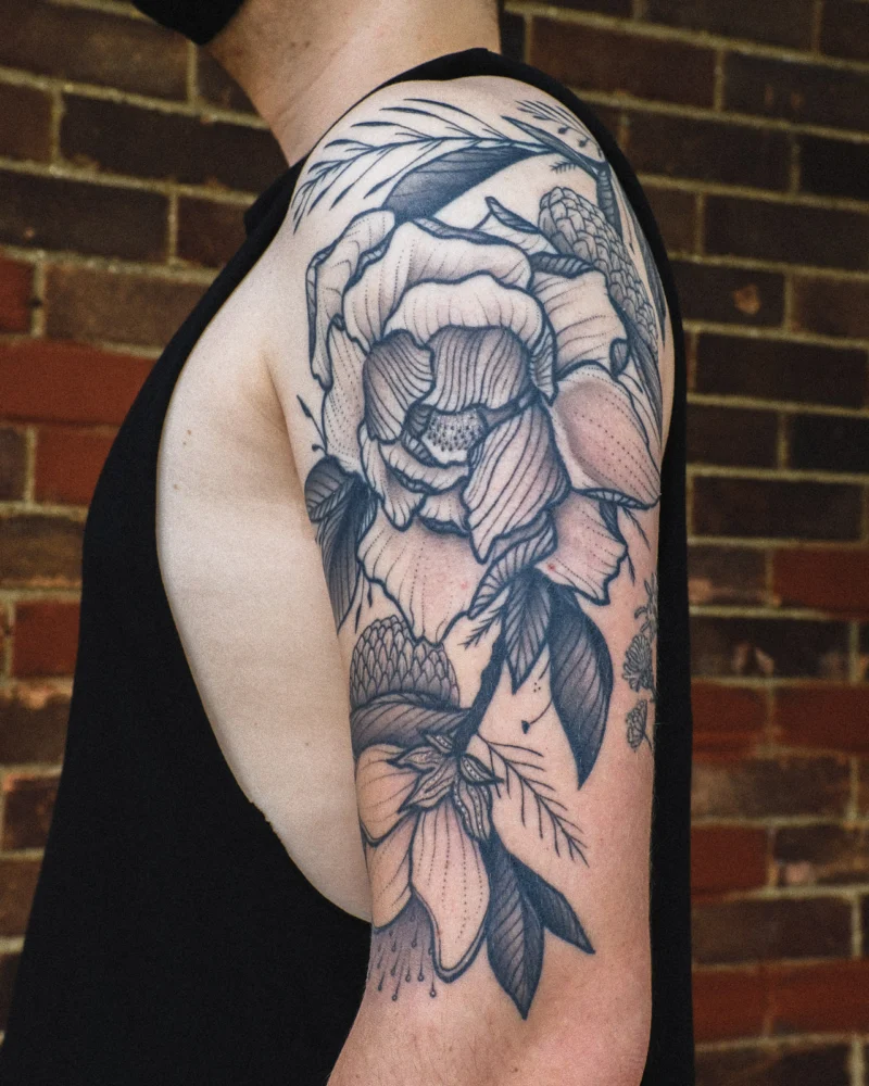 Freehand botanical tattoo across the arms