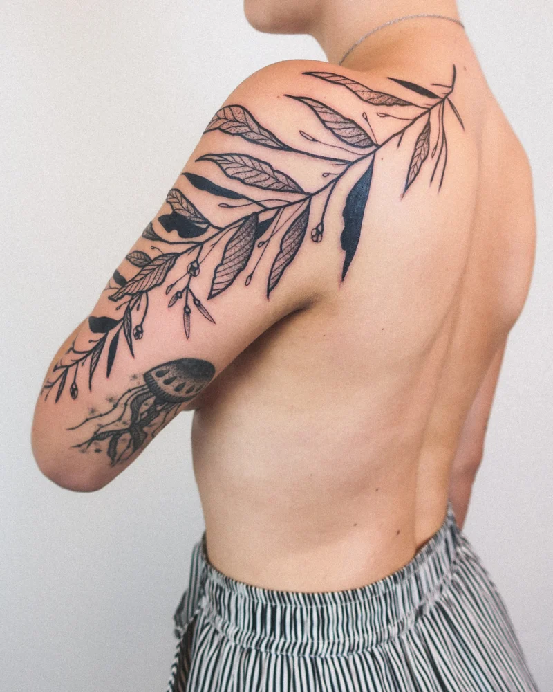 Freehand botanical tattoo across the arms