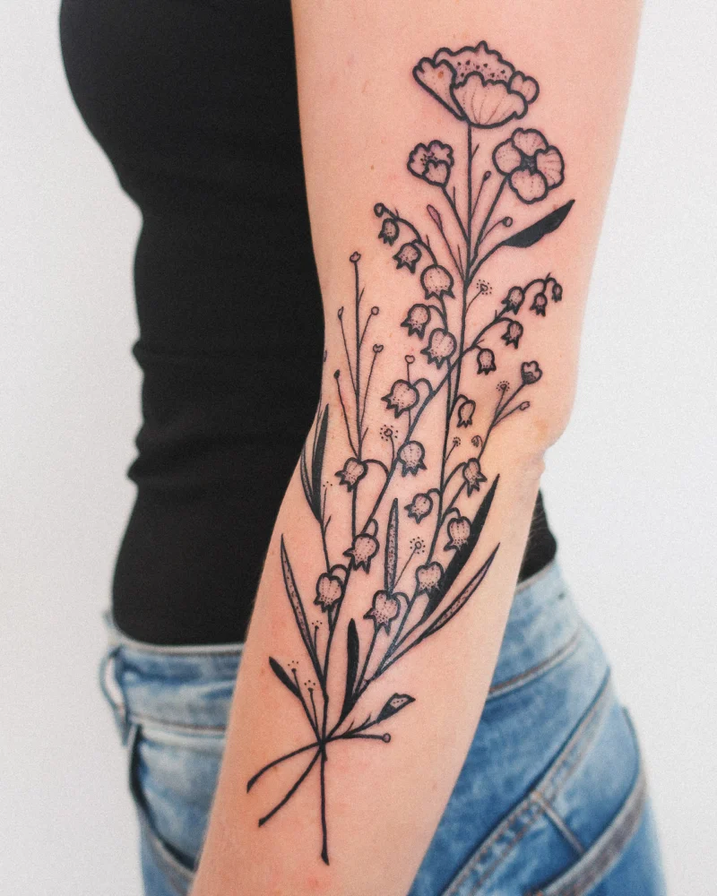 Freehand botanical tattoo across the arms