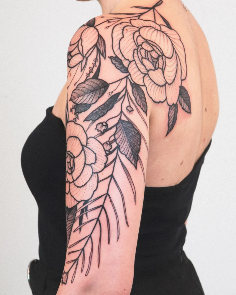 Another view of a freehand botanical tattoo across the arms