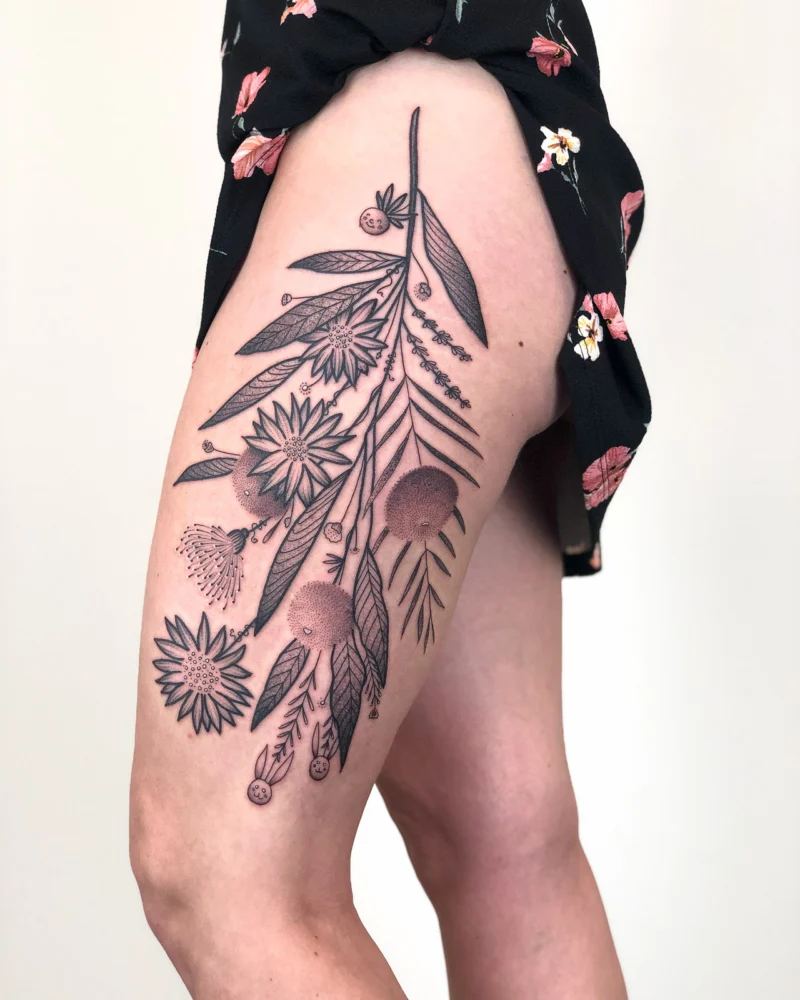 Freehand botanical tattoo across the legs