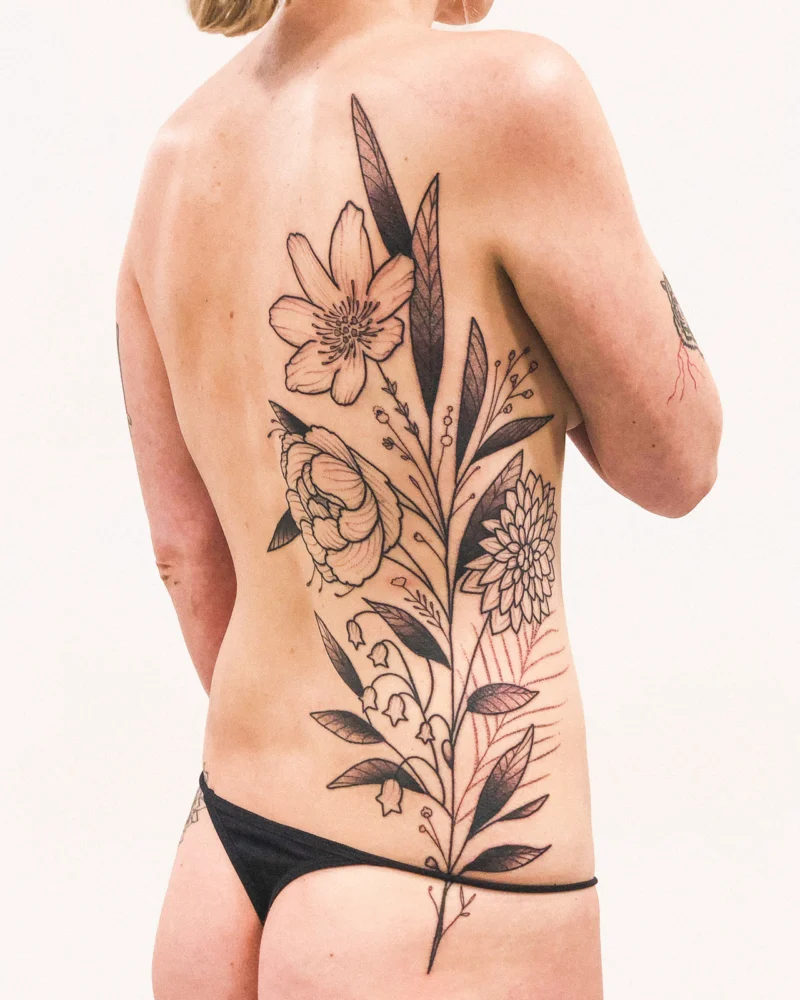 Freehand botanical tattoo across the back