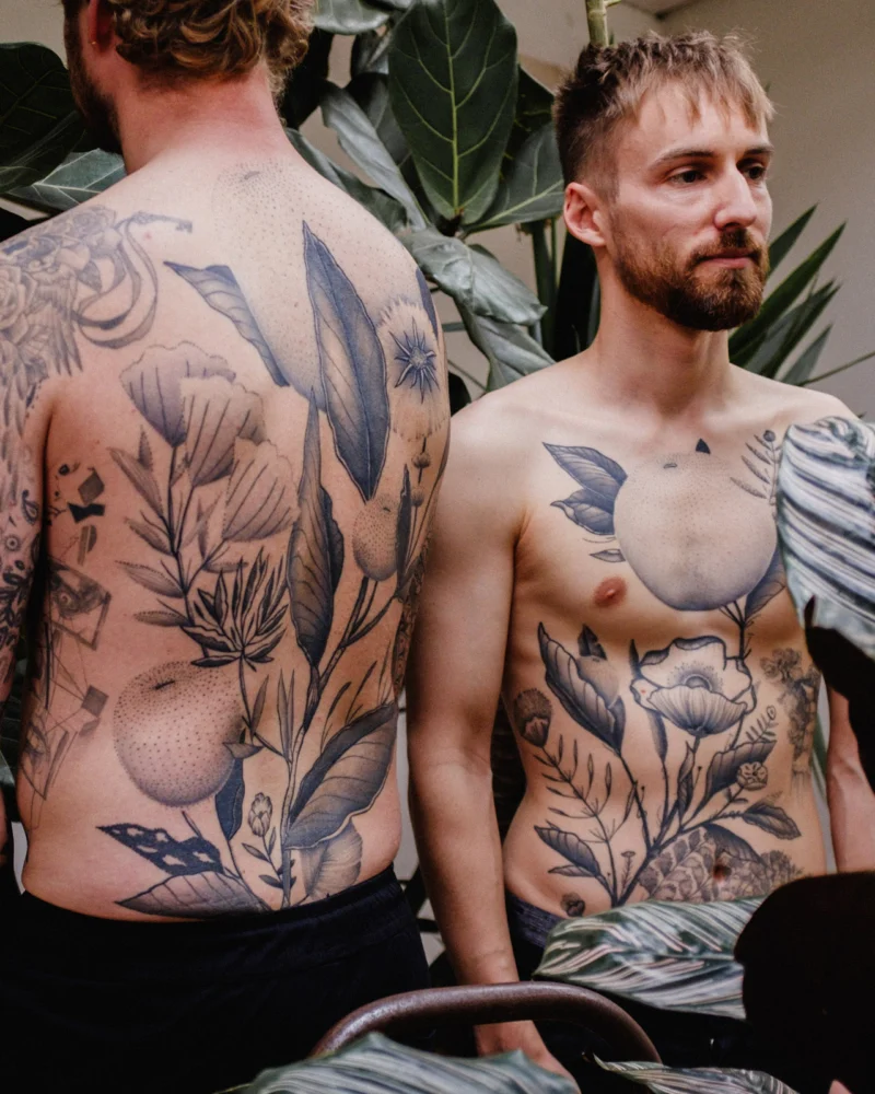 Freehand botanical tattoo across the front torso and back