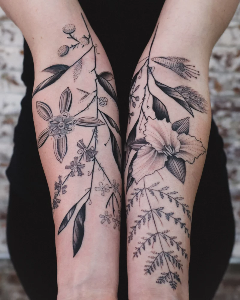 Freehand botanical tattoo across the arms