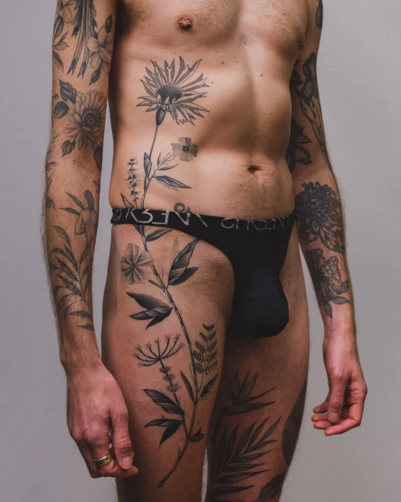 Freehand botanical tattoo across the front torso