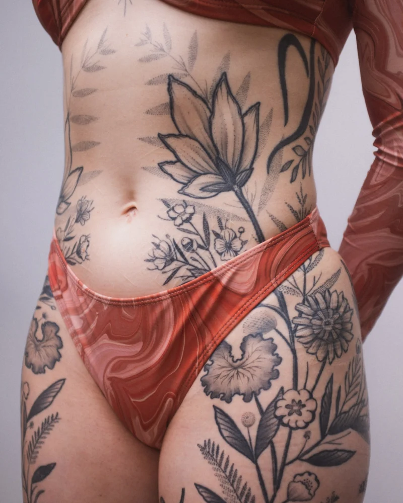 Freehand botanical tattoo across the front torso