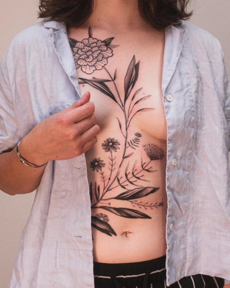 Freehand botanical tattoo across the front torso