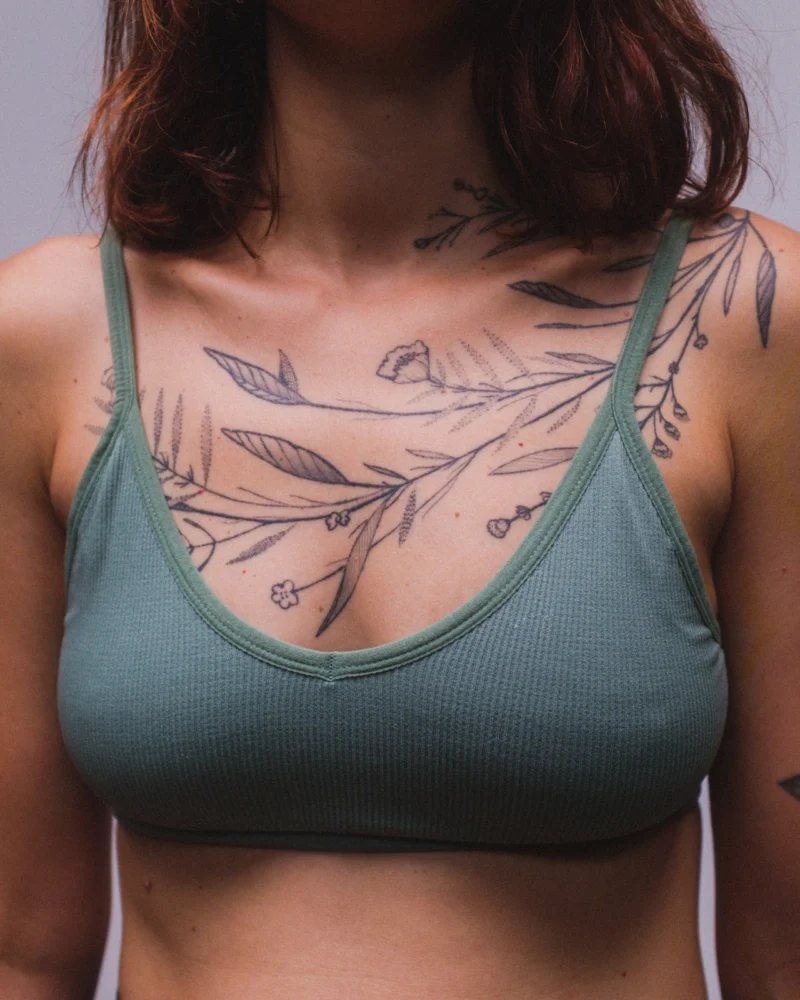Another view of a freehand botanical tattoo across the front torso