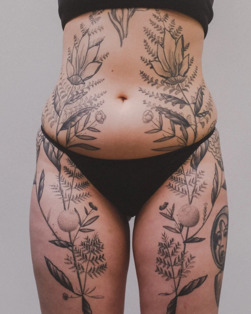 Freehand botanical tattoo across the front torso