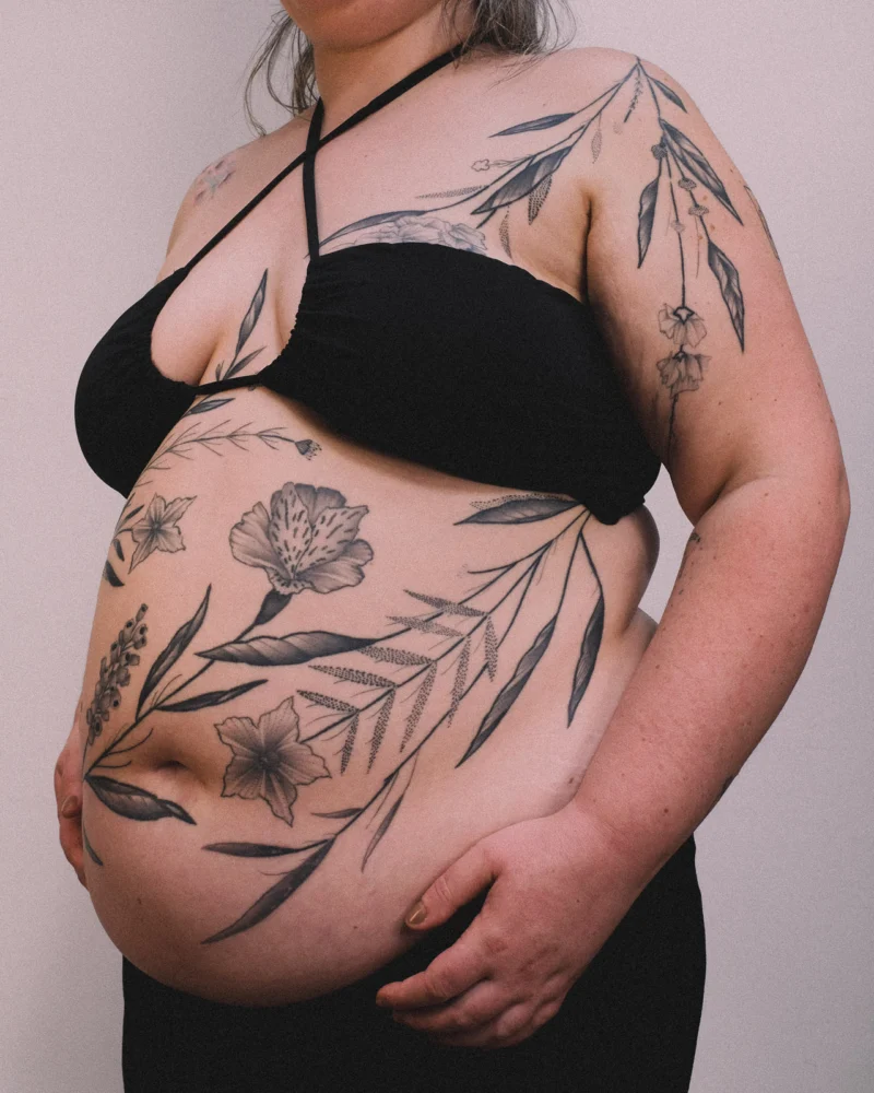 Freehand botanical tattoo across the front torso