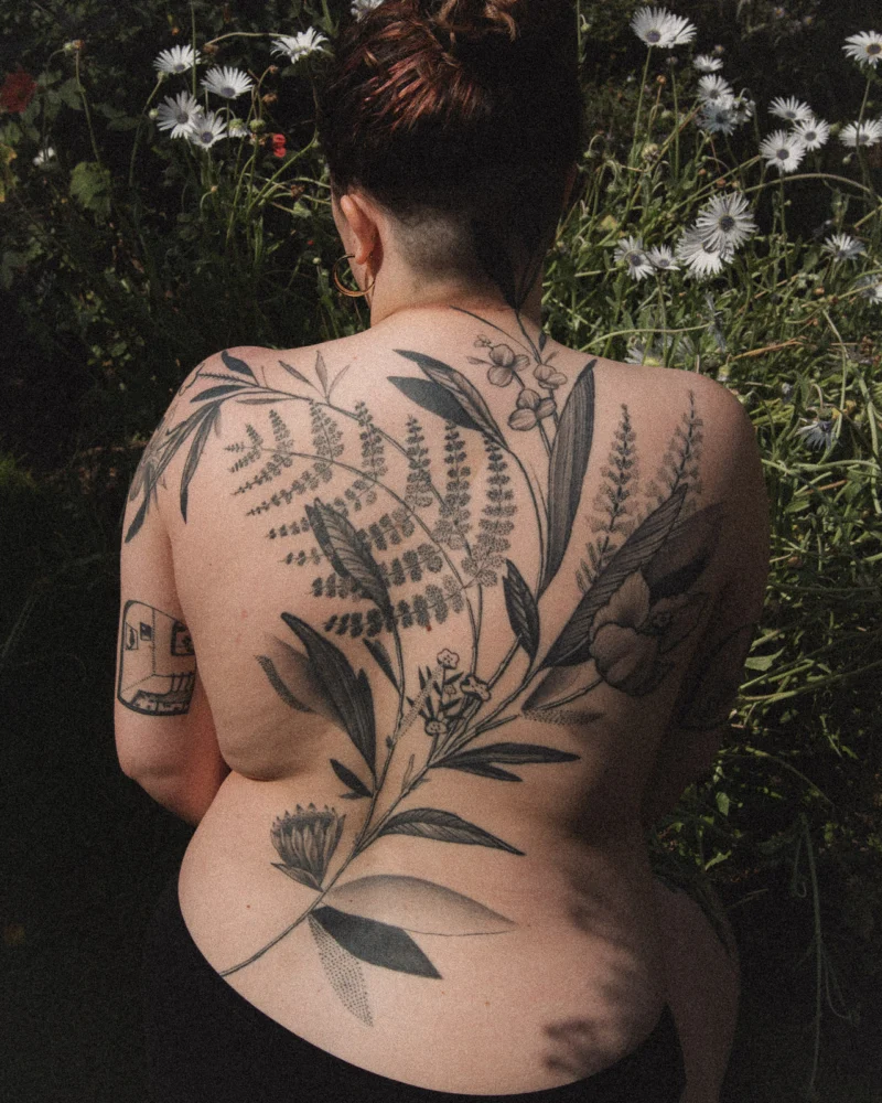 Freehand botanical tattoo across the back