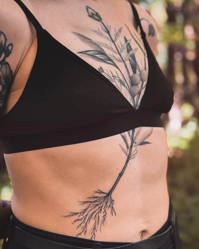 Another view of a freehand botanical tattoo across the front torso