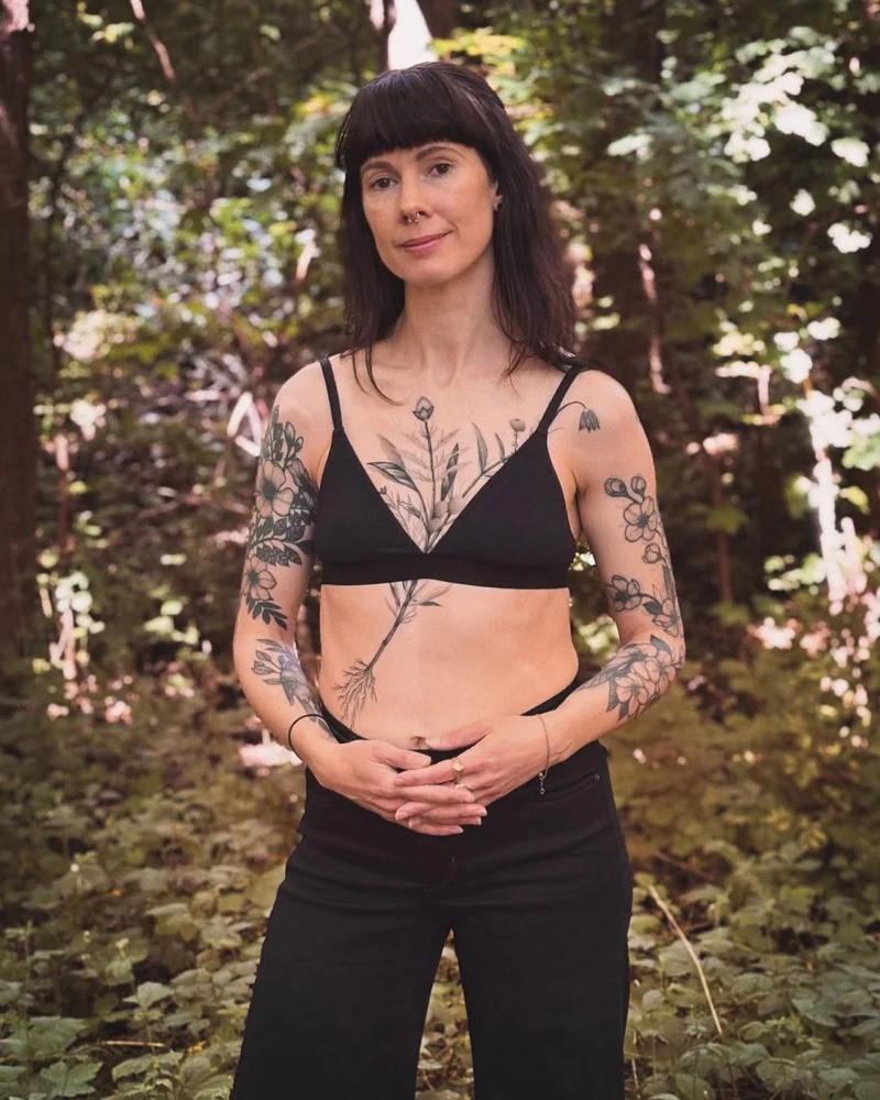 Freehand botanical tattoo across the front torso